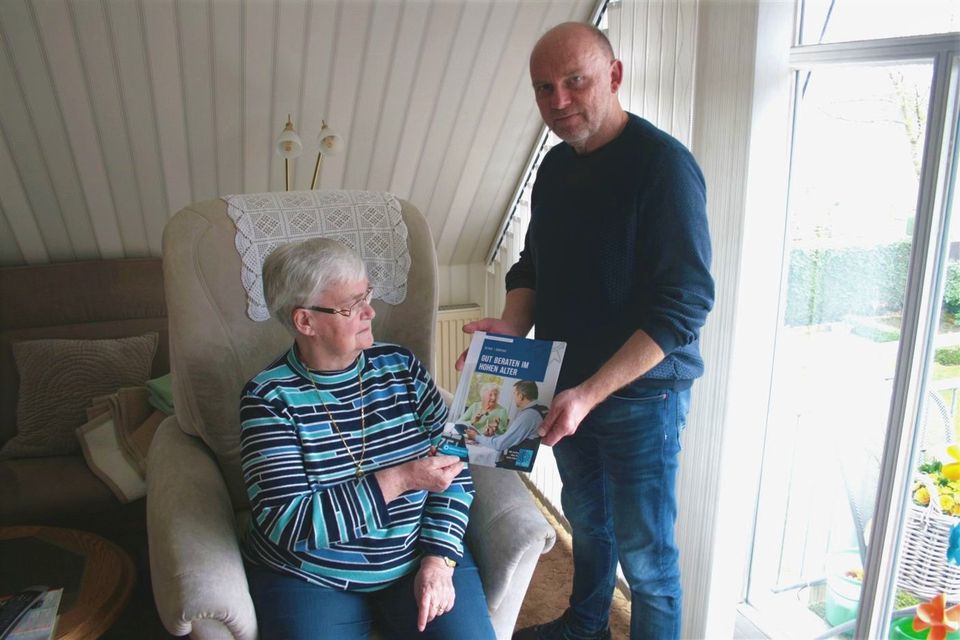 Chief inspector hands brochure to senior citizen